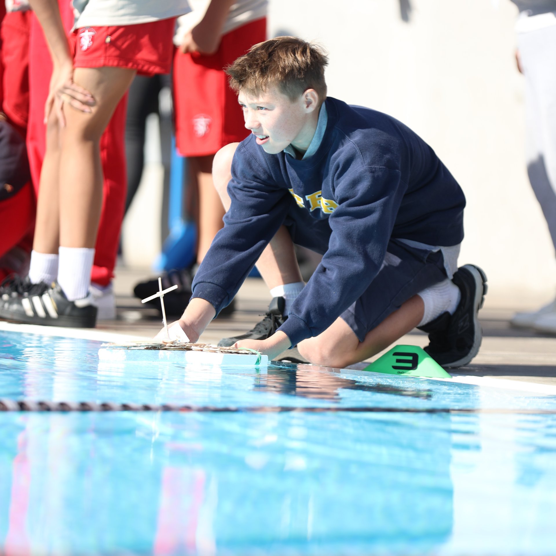 Eagerly anticipating his team's boat race at the regatta.